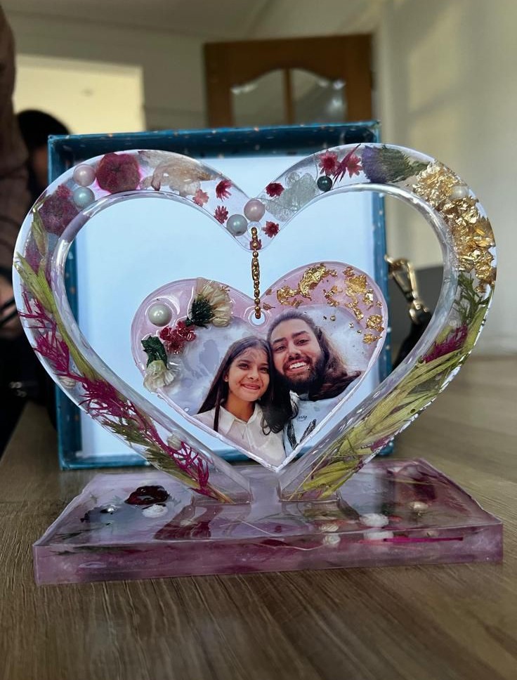 Handmade resin heart photo frame with dried flowers and a photograph